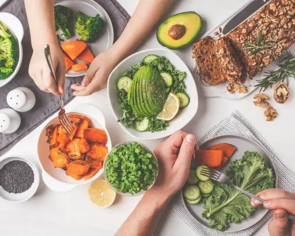 Avocado, carrots, and other vegtables on a table
