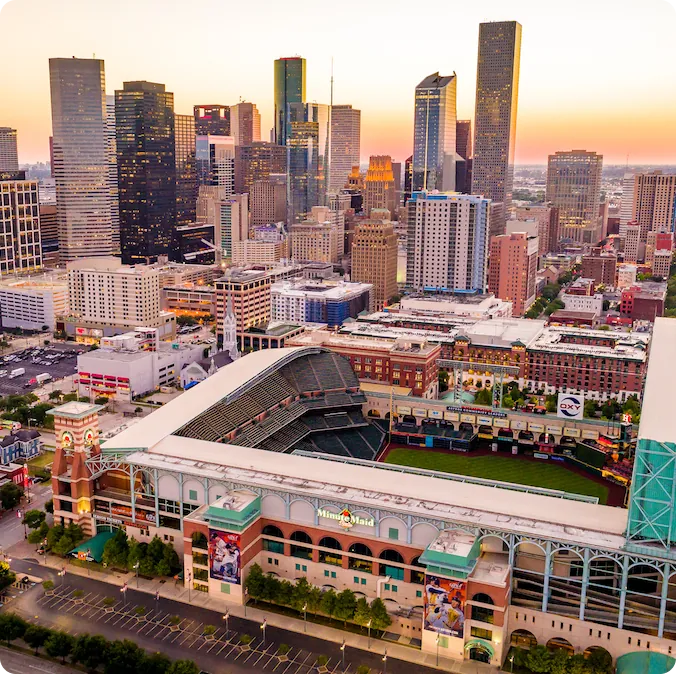 The skyline of downtown Houston with high-rise buildings and the Daikin Park
